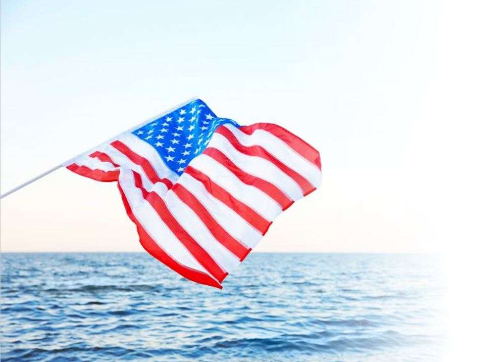 American flag over ocean 